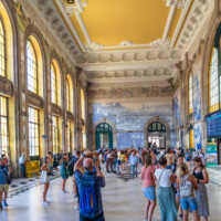 Famous for its tiles depicting historical events and scenes of country life, the train platforms are right through the door on the right.