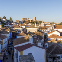 View of the castle and the castellated walls of Óbidos from the other end of the village.